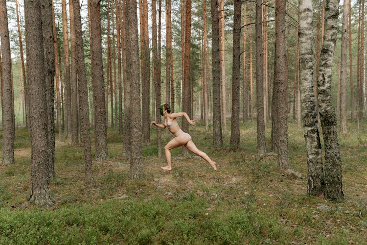 A Woman Wearing Mask Running In The Forest