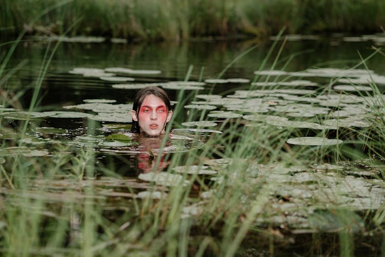 A Man Swimming In The Lake