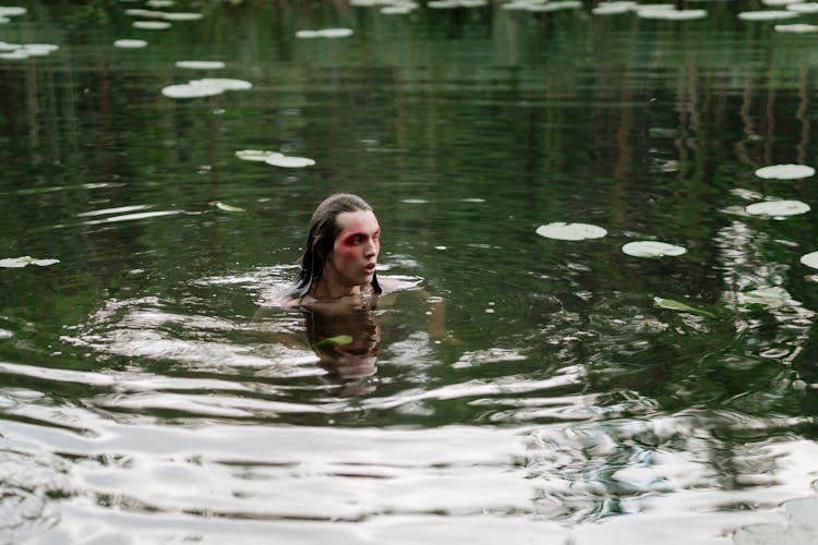 A Person Swimming In The Lake