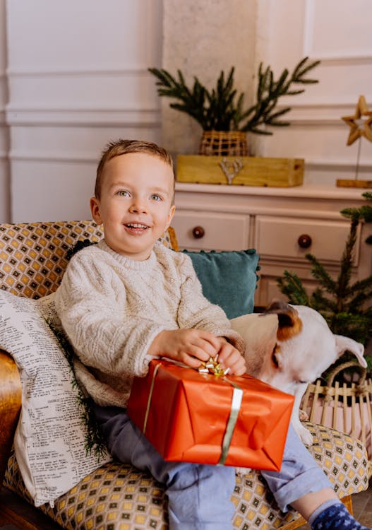 Child opening his Christmas Eve box