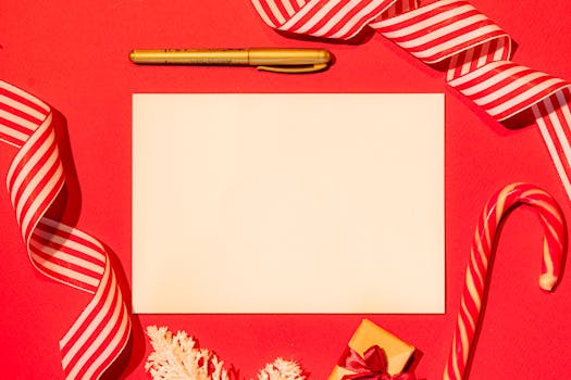 Top view of a blank card surrounded by Christmas decorations and candy cane.