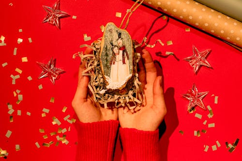 A Person Holding a Christmas Decoration