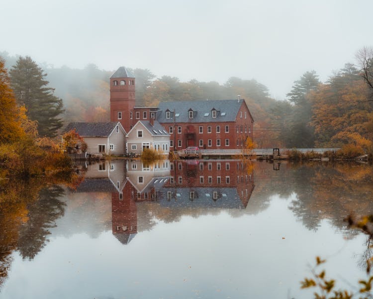 Old Manor Located On Coast Of Reflective Pond