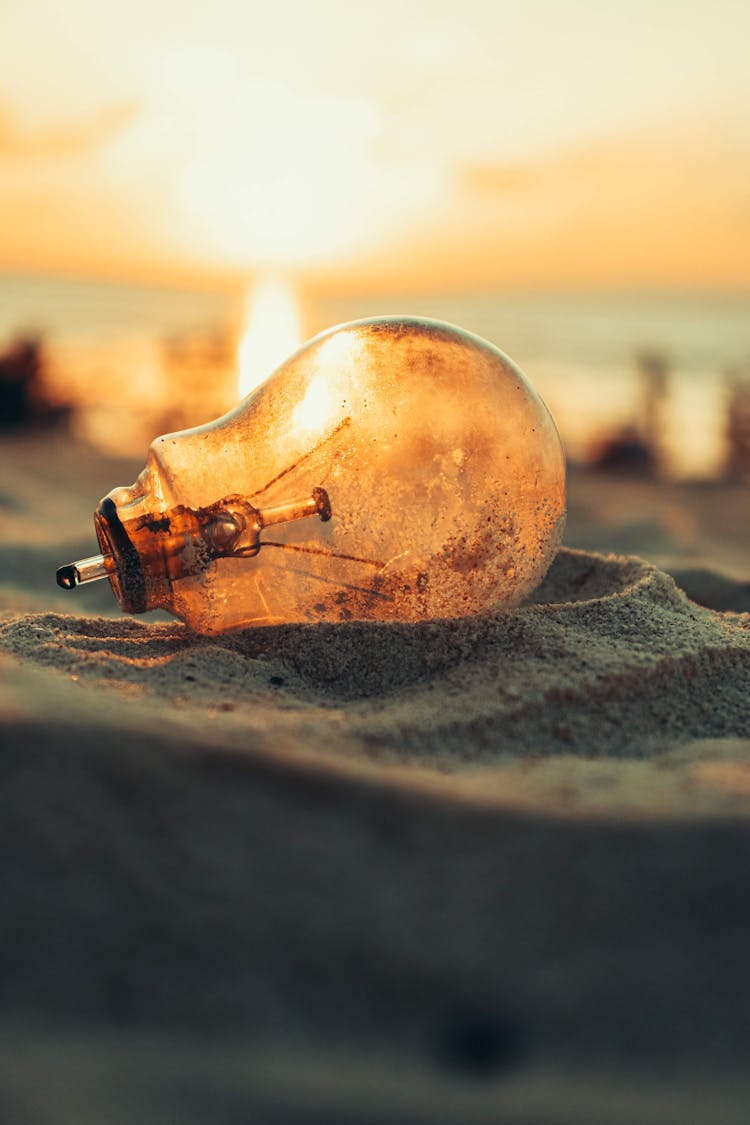 Light Bulb On Sandy Beach