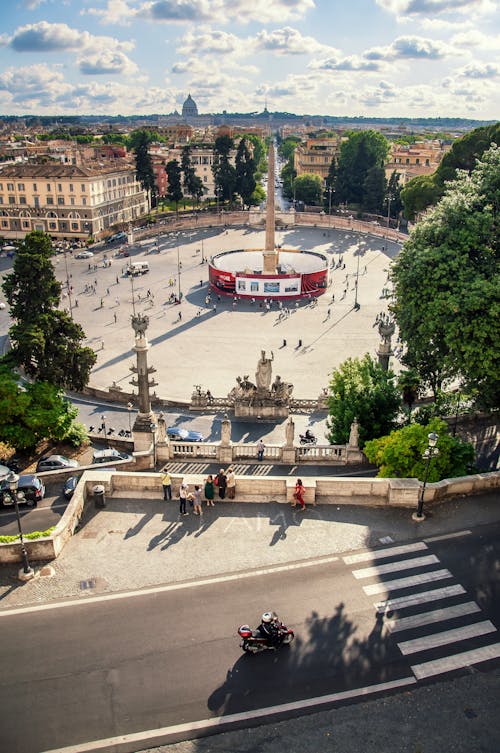 Famous historic landmark located in Rome in Italy and called Piazza del Popolo in sunny summer day under blue cloudy sky with buildings on background