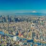 A panoramic view of the expansive Tokyo skyline with Mount Fuji rising in the distance.