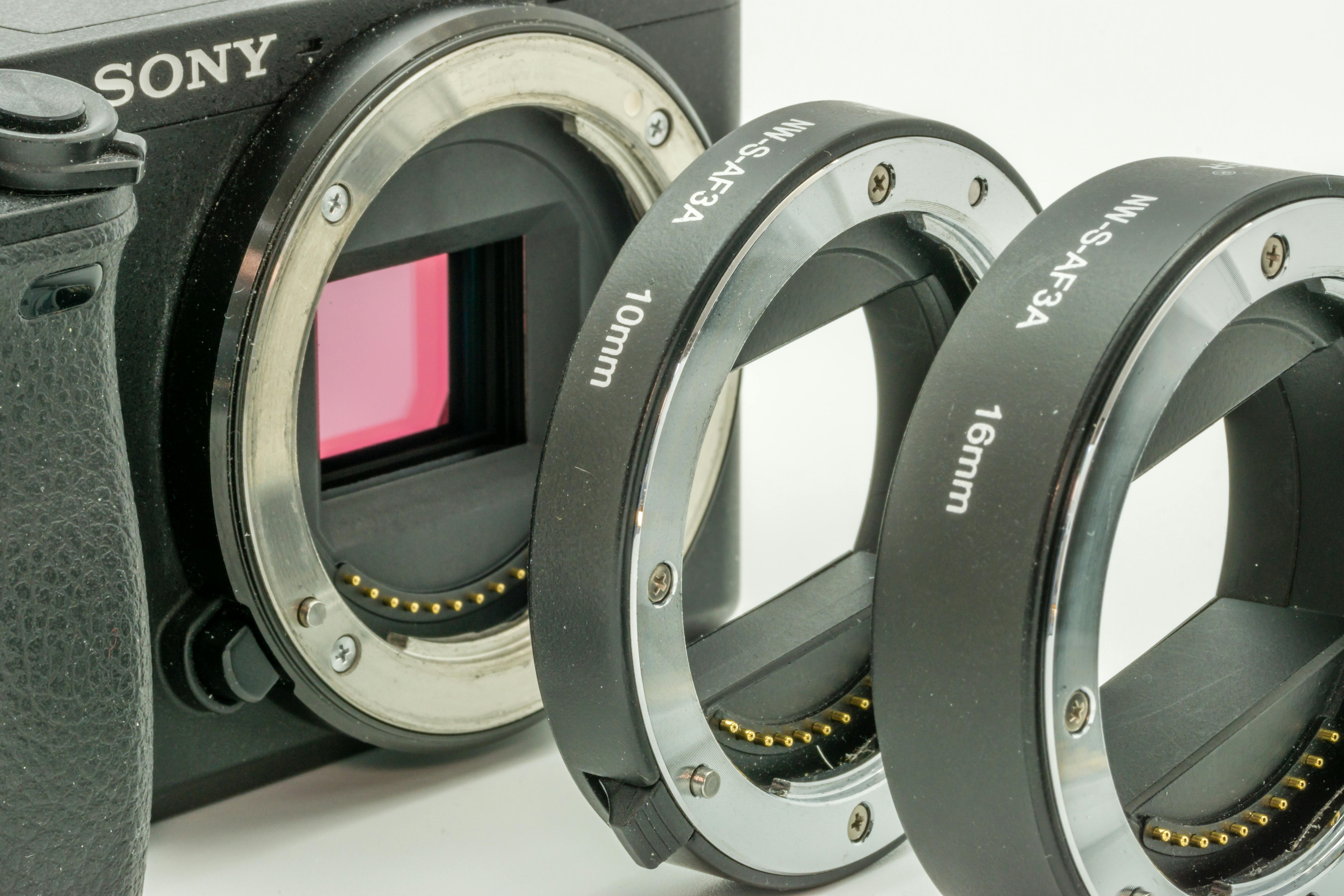 Detailed view of a camera body with attached extension tubes for macro photography.