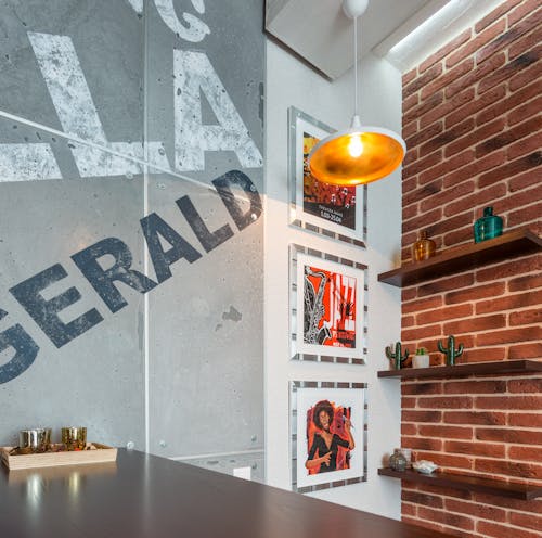 Interior of creative dining area with various pictures on wall and wooden table