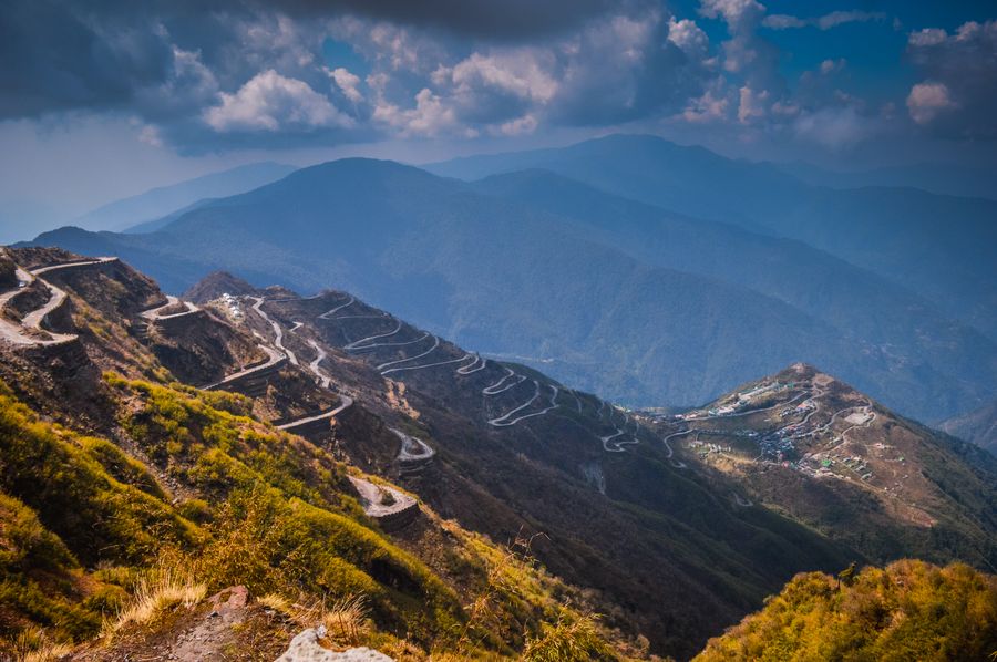 Winding mountain road through the green landscape of Sikkim