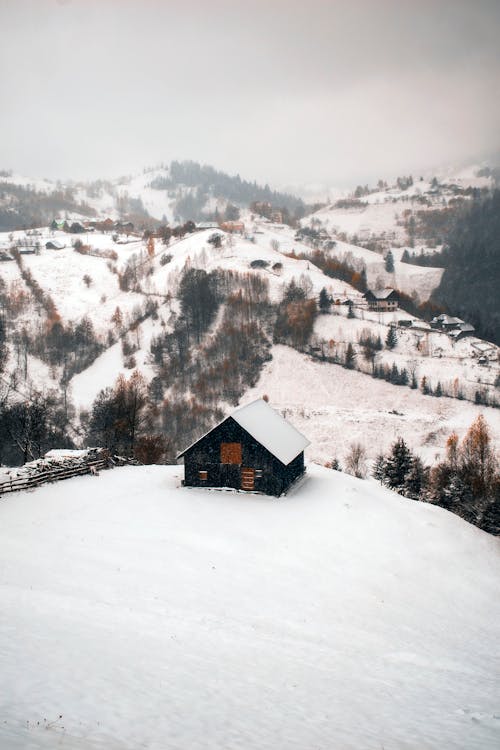 A Wooden House on Snow Covered Ground