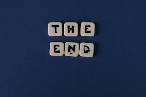Scrabble Tiles Forming The Words "The End" On Blue Background