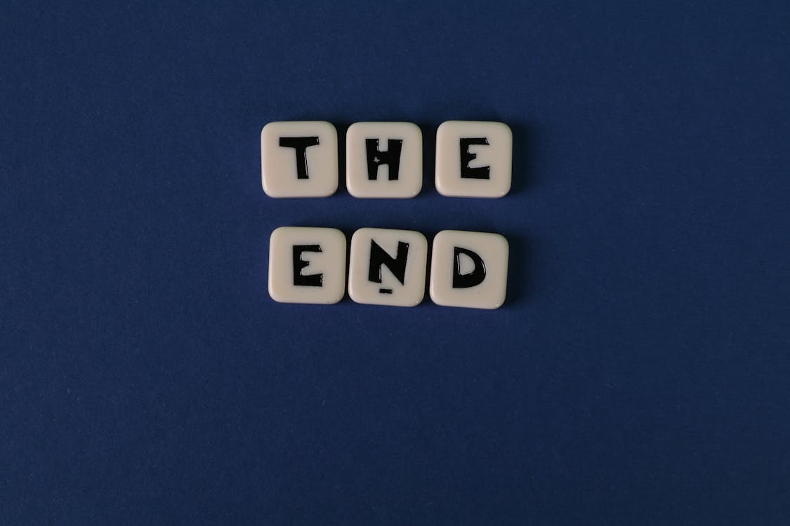 Free Scrabble Tiles Forming The Words "The End" On Blue Background Stock Photo