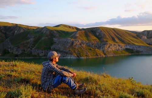 Free A serene moment of solitude by a lake in the hills of Tehran, Iran. Stock Photo