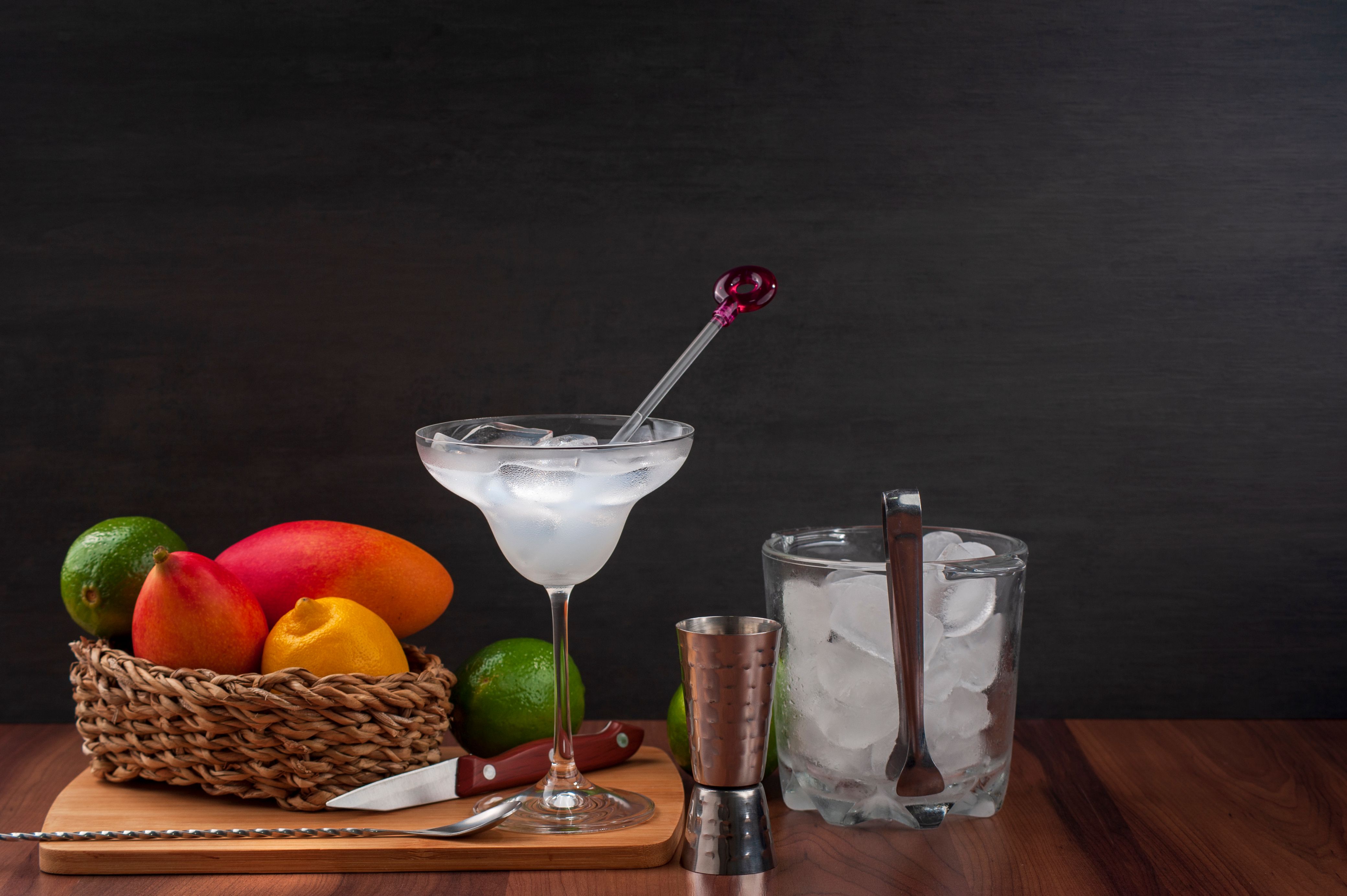 Glass of Mango Passionfruit Margarita with lime and chile garnish