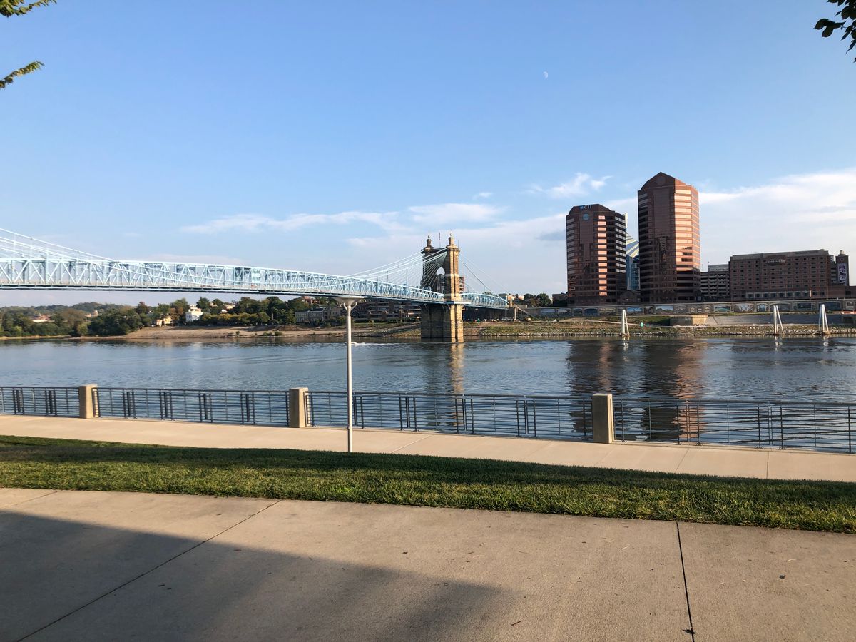 The Roebling Suspension Bridge over the Ohio River under a clear sky