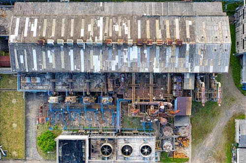 Industrial facility with rusty warehouses with pipes