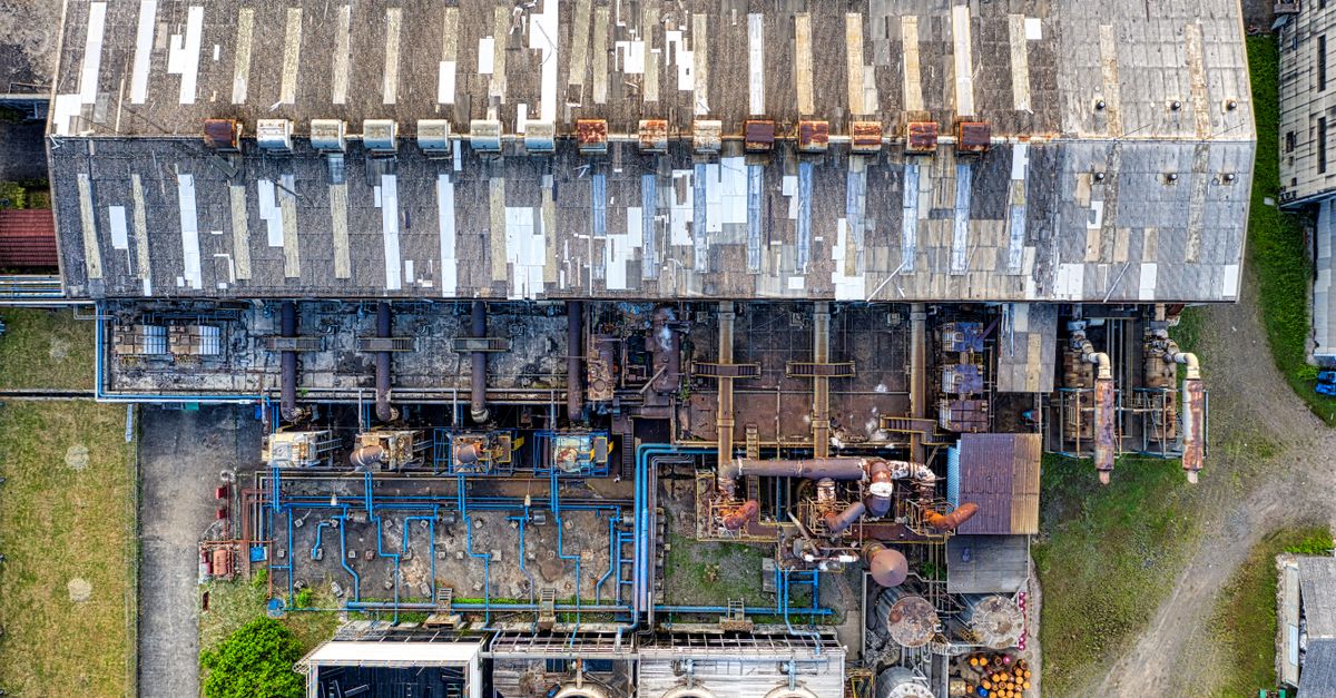 Drone view of old industrial buildings and reservoirs of factory with cooling fans
