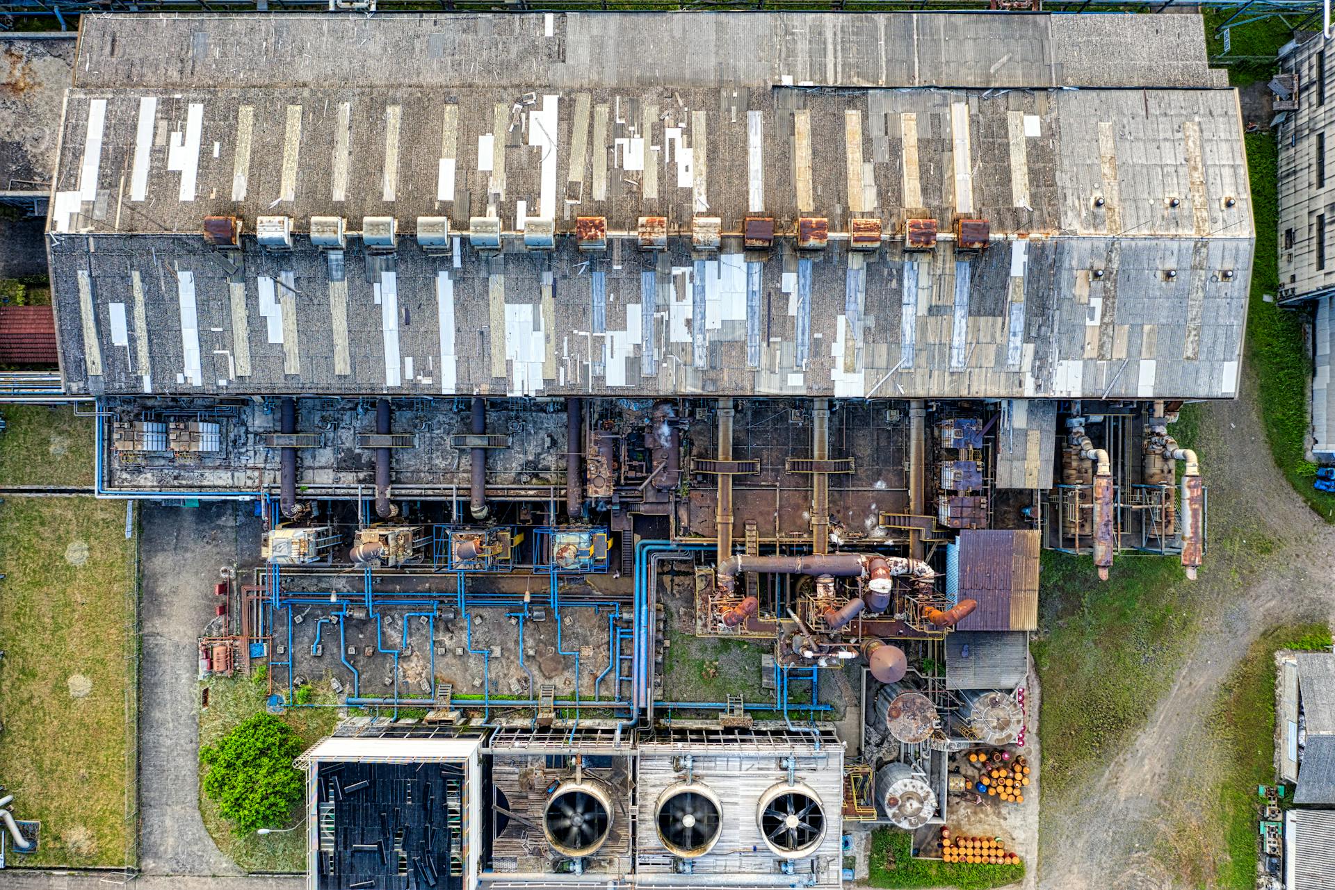Industrial facility with rusty warehouses with pipes