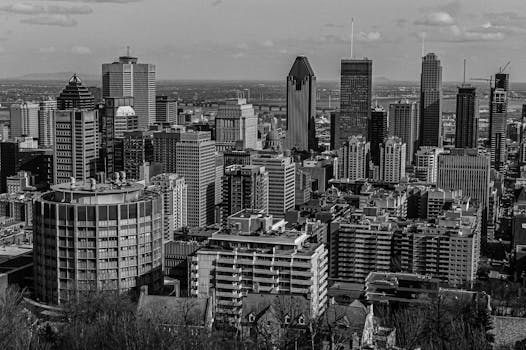 Black and white aerial view of Montreal's urban skyline featuring skyscrapers.