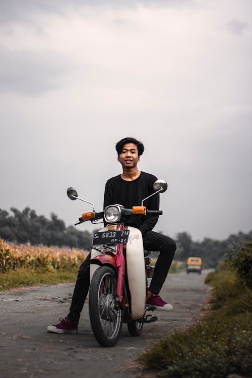 Man in Black Outfit Sitting On A Motorcycle