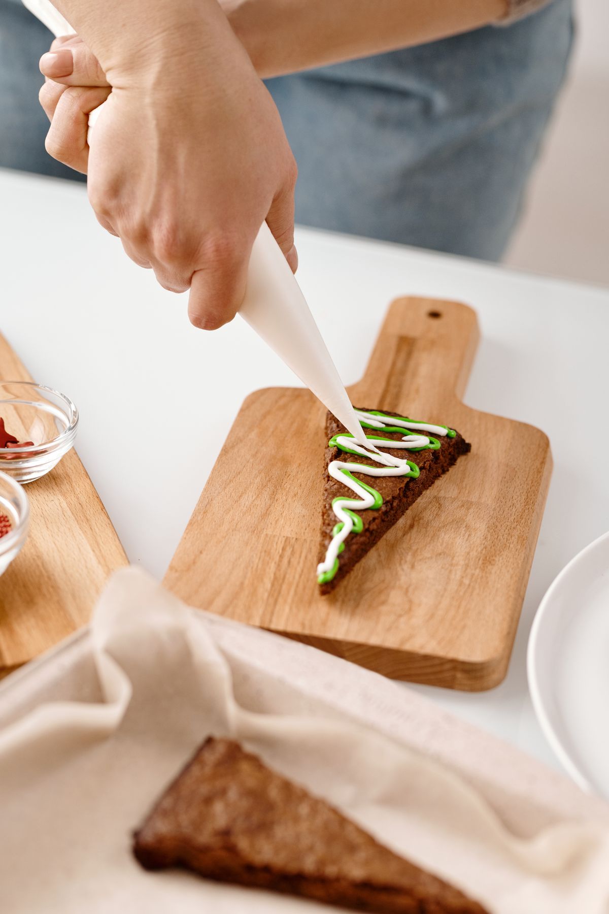 Decorating a Christmas cookie with royal icing