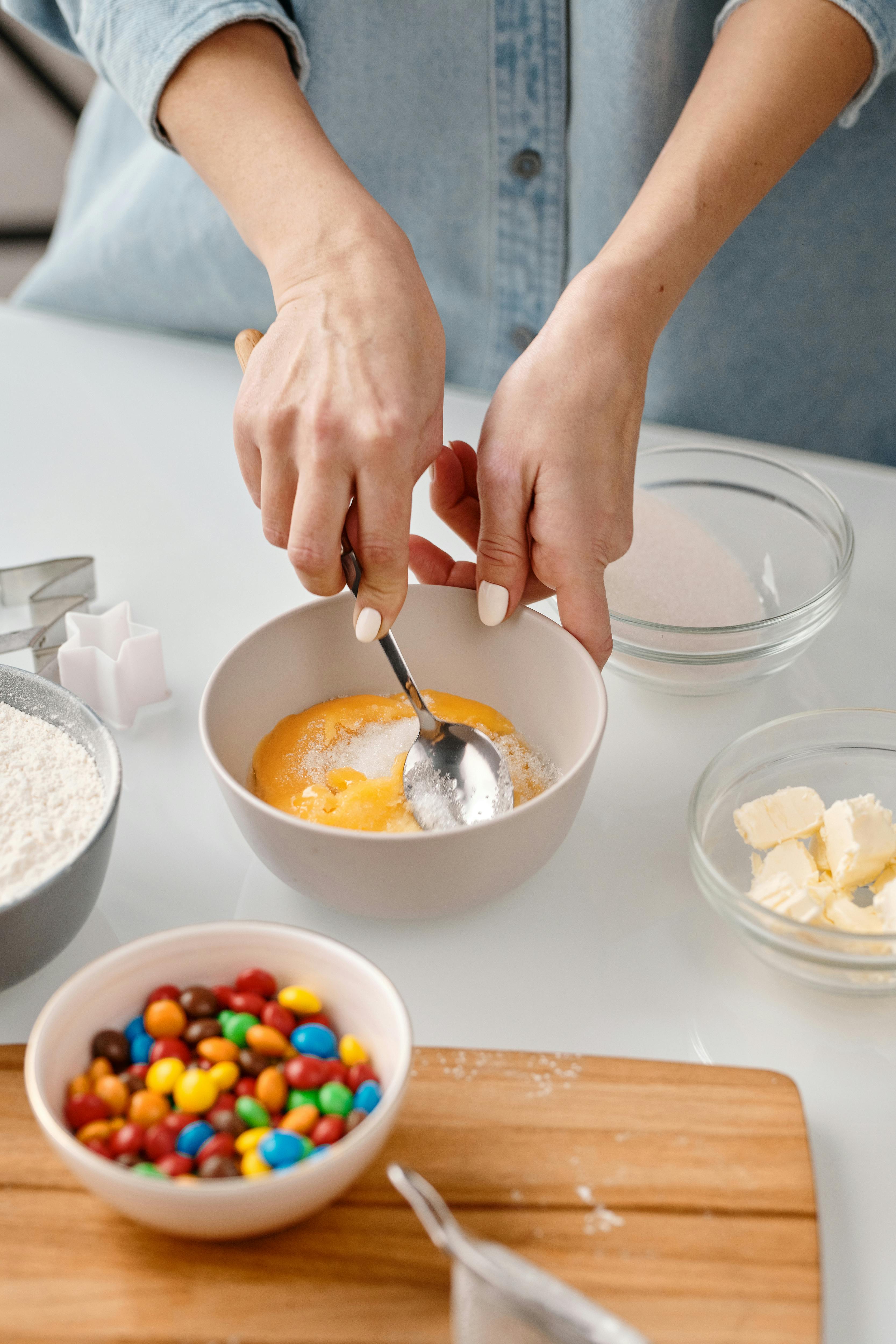 person mixing yellow eggs in a bowl