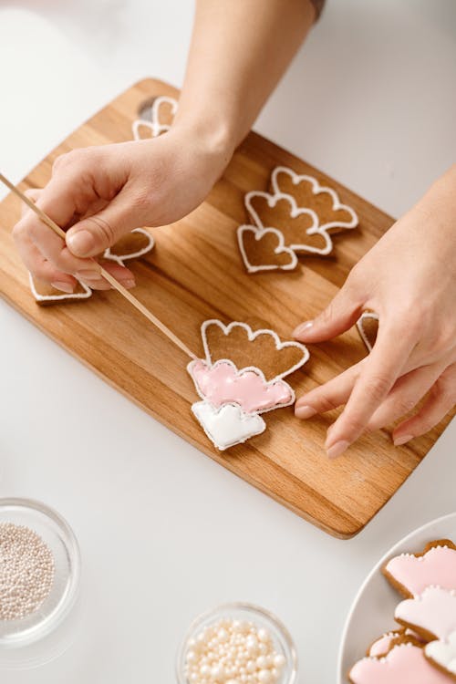 Persona Decorando Galletas Con Forma De árbol De Navidad