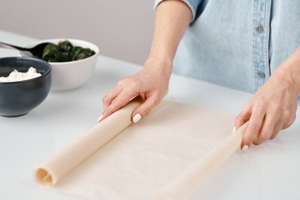 Butter paper used on a kitchen counter with dough