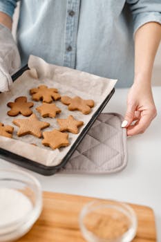 Close-up of freshly baked gingerbread cookies on a tray in a home kitchen.