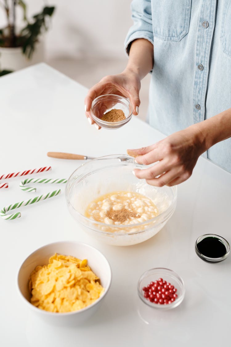 Person Mixing Baking Ingredients In A Bowl