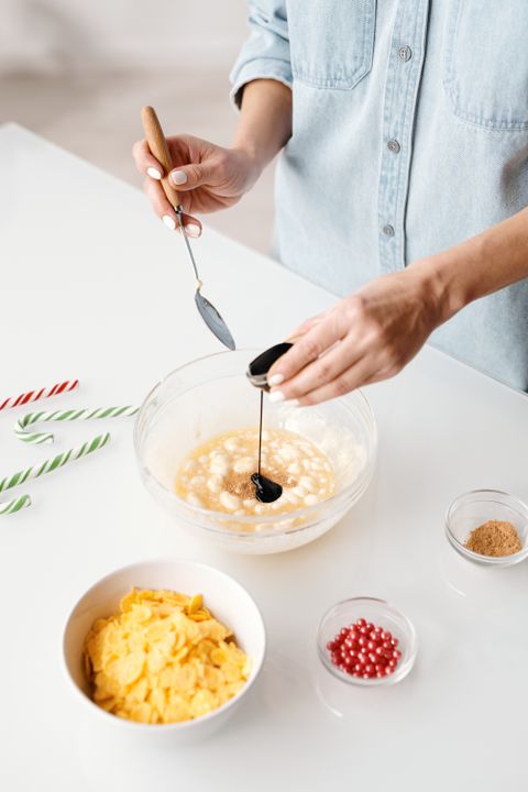 Eggless Baking: The Complete Substitute Guide for Every Recipe 2 A person mixes dark batter in a bowl during festive baking preparation — the foundation of every great eggless cake.