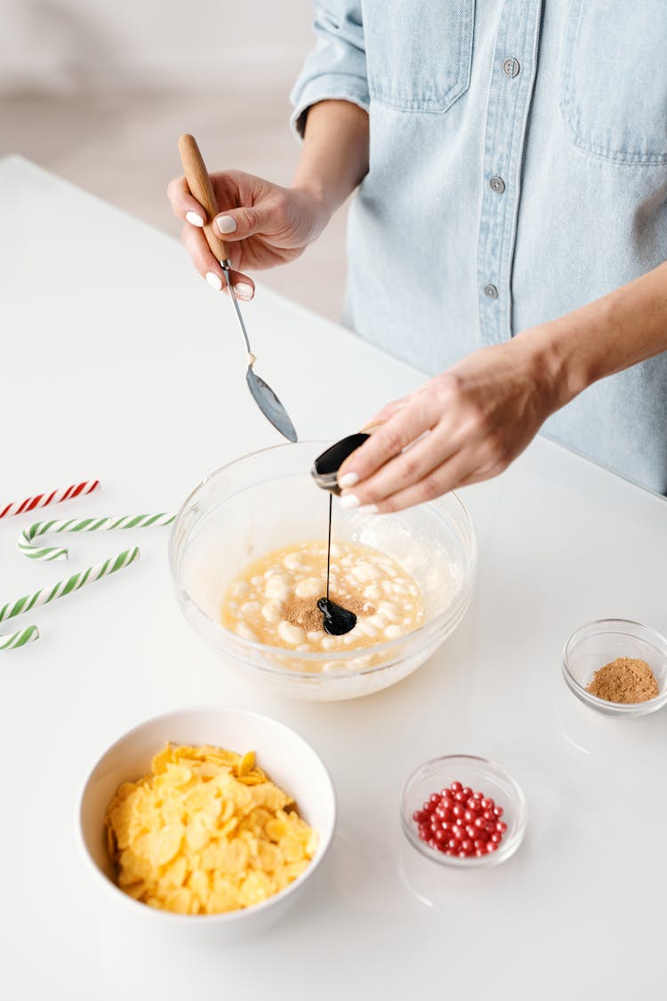 Person Mixing Baking Ingredients In A Bowl