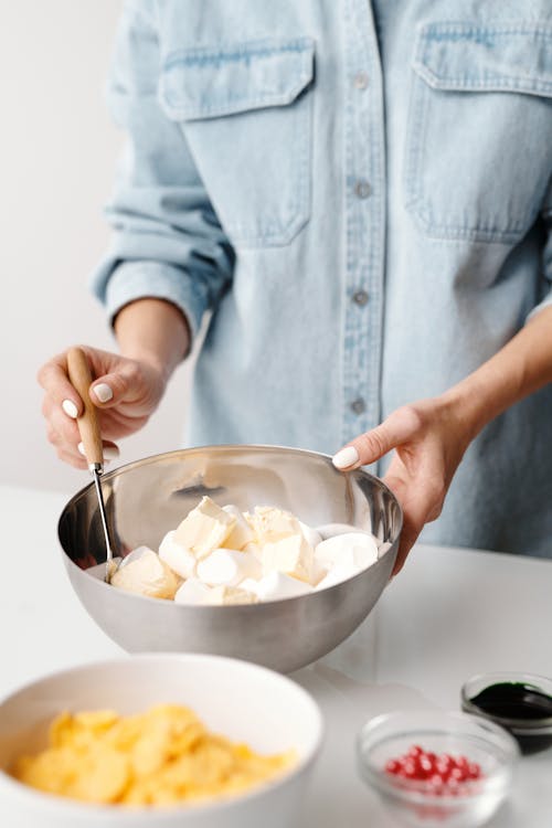 Free Person Holding Stainless Steel Bowl With Marshmallows Stock Photo