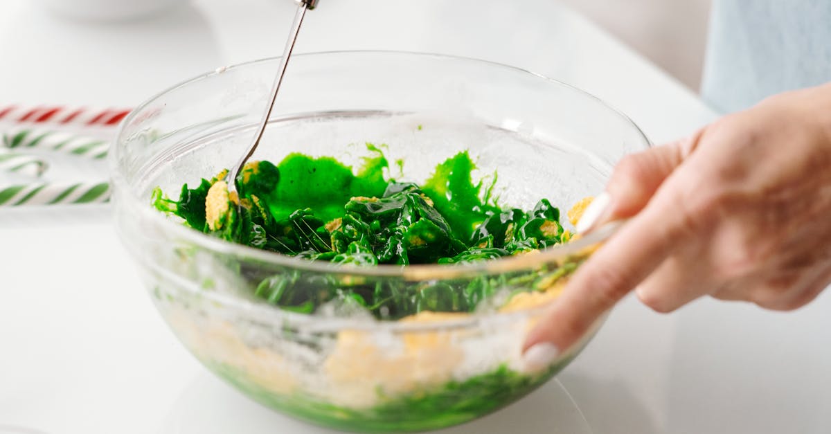 Person Mixing a Vegetable Salad in a Bowl
