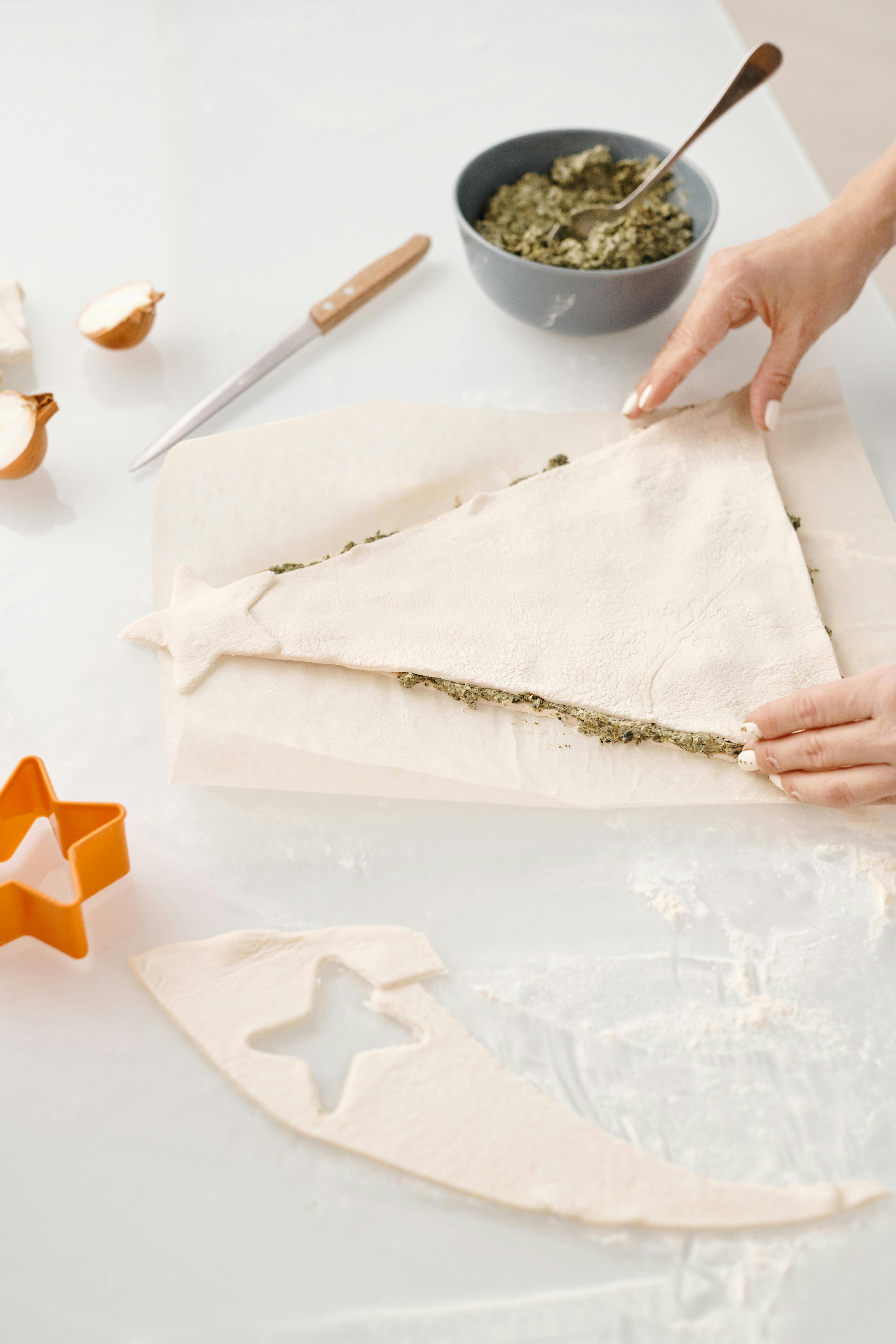 person making a christmas tree shaped bread with fillings