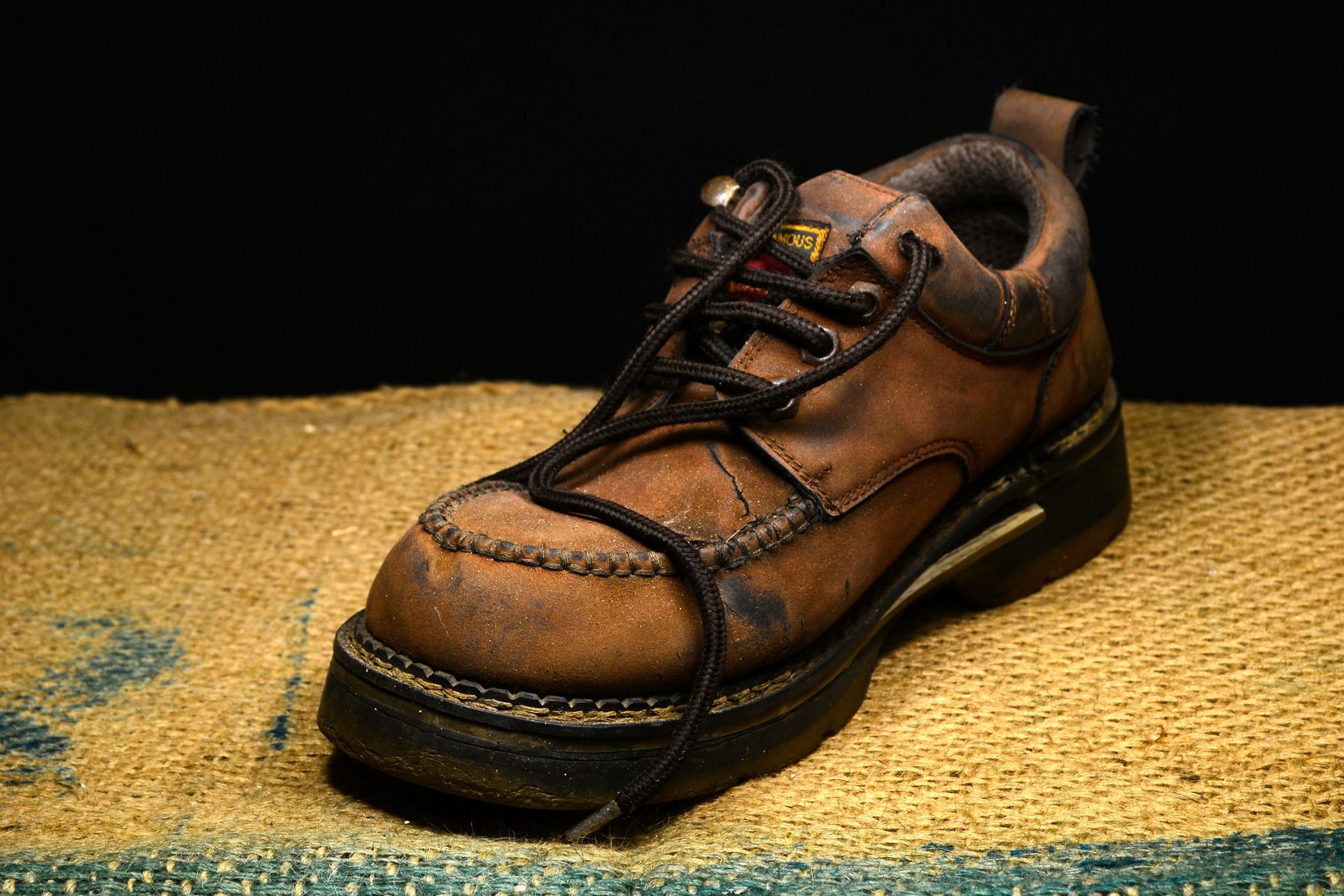 Brown and Black Leather Work Boots on Brown Surface