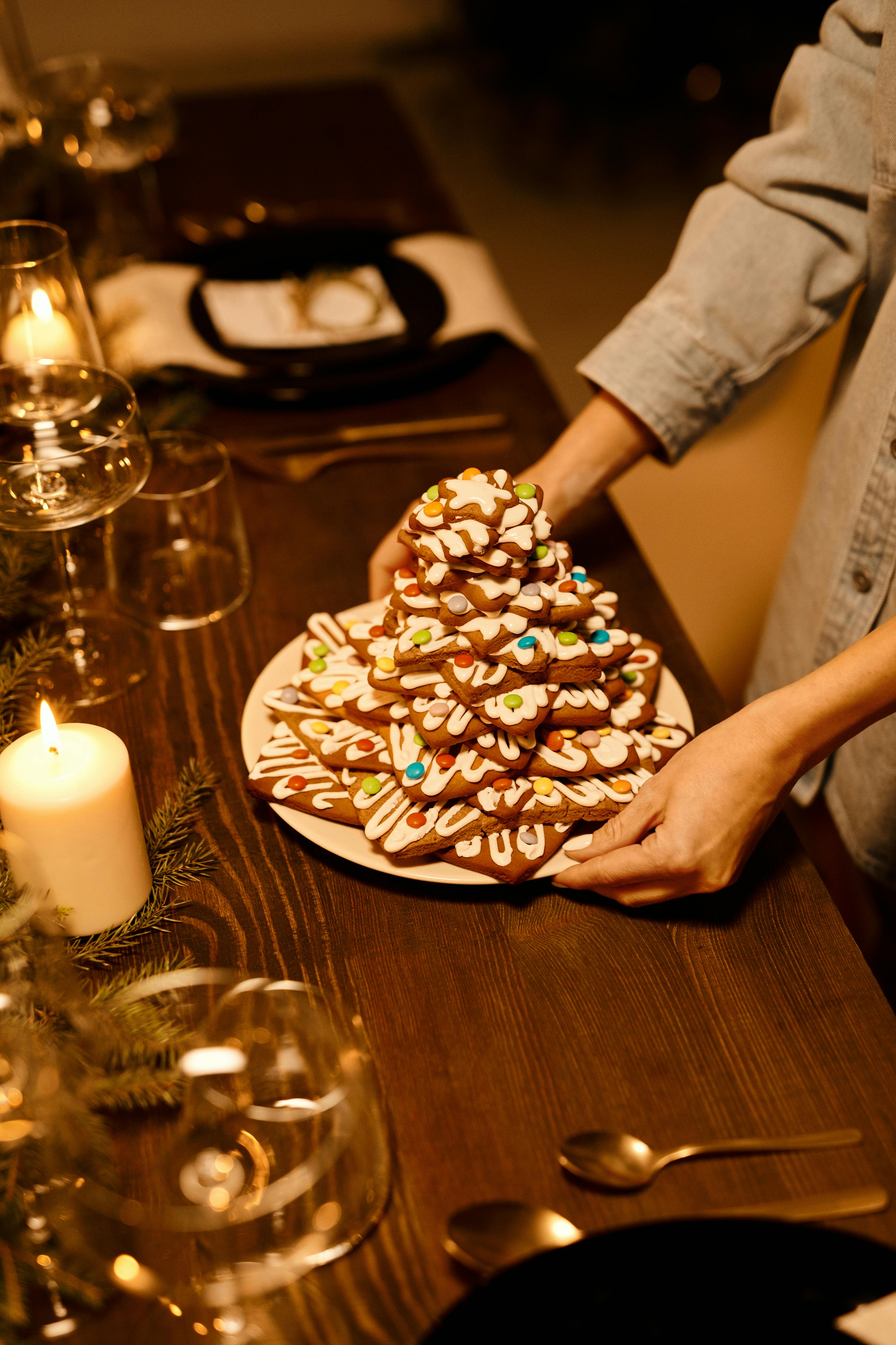 person serving a stack of biscuits on a plate