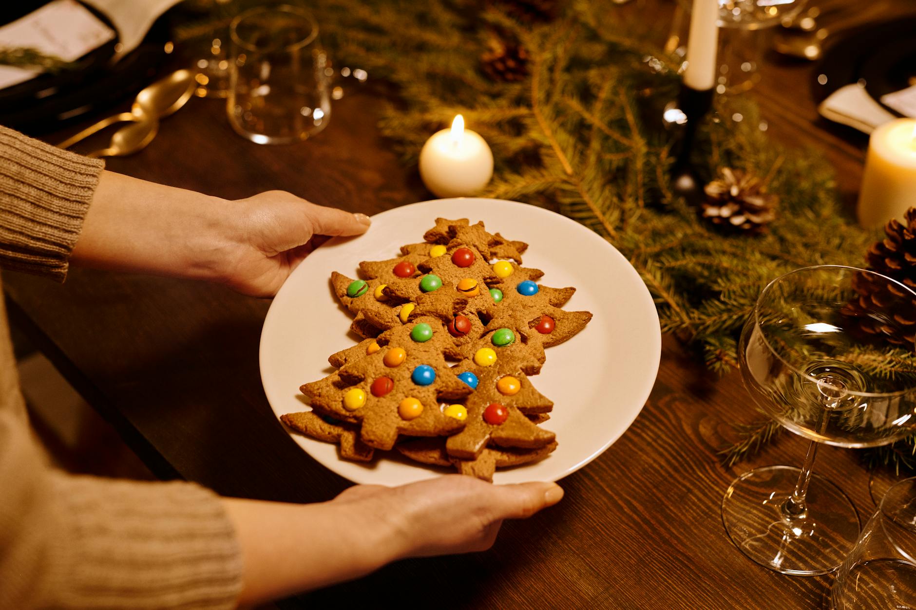 Person Serving a Platter of Christmas Tree Shaped Cookies