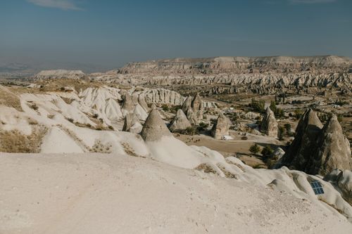 Free Scenery view of rough volcanic peaks and fairy chimneys in Cappadocia scattered on spacious highlands under cloudless blue skies Stock Photo