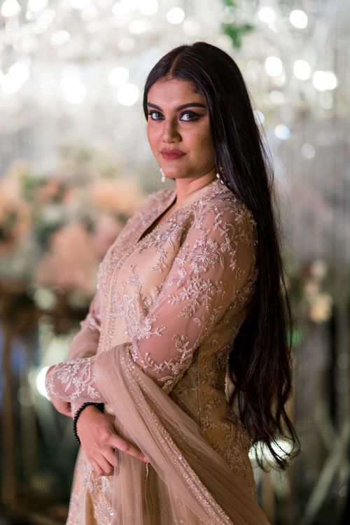 Free Elegantly dressed woman in traditional attire posing indoors with a soft focus background Stock Photo