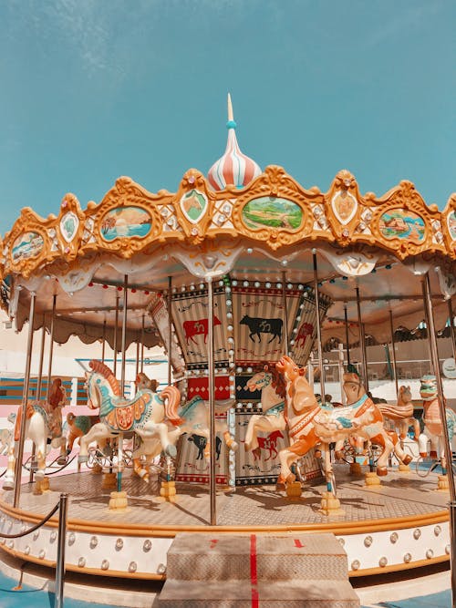 Free White and Brown Carousel Under Blue Sky Stock Photo