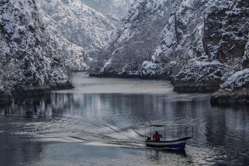 A Man Riding a Boat on the River