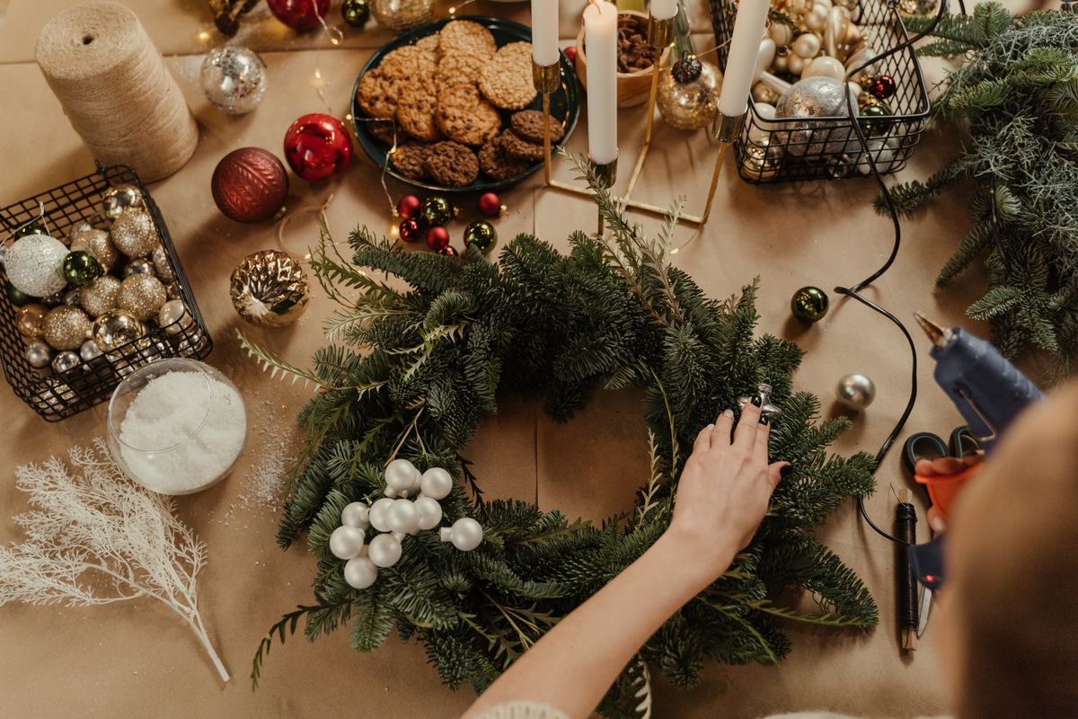 Festive Christmas wreath decorated with ornaments and cookies on a table