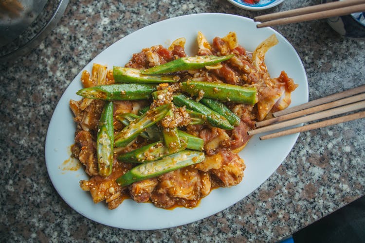 Marinated Meat With Okra Slices On White Ceramic Plate