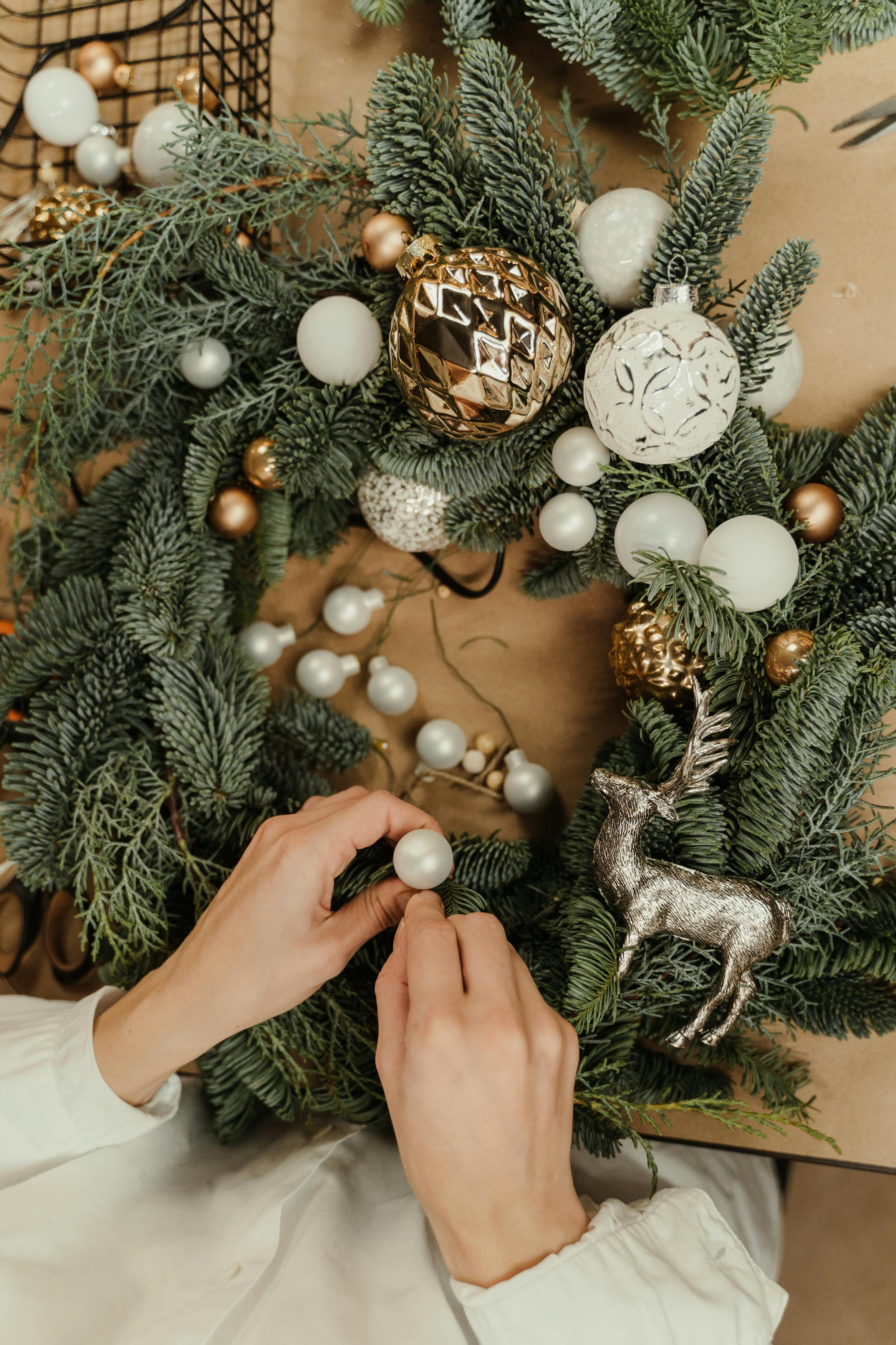 a person putting a design on the wreath