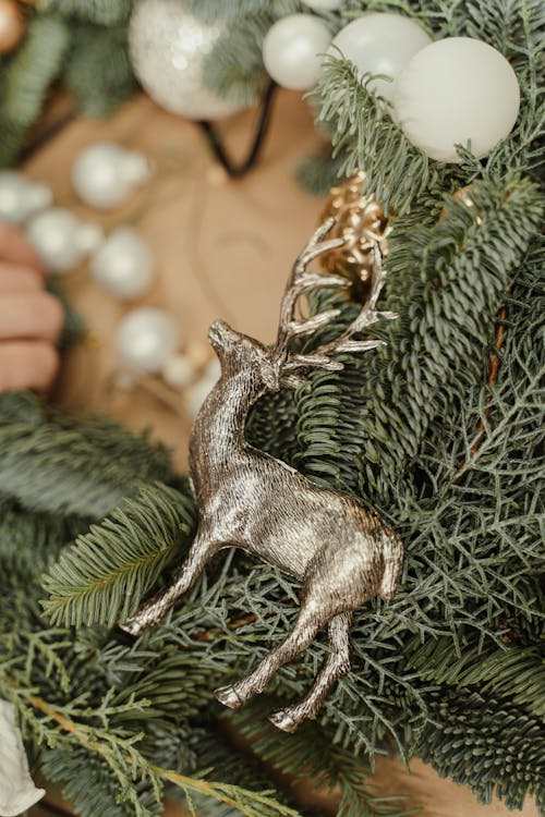 Gray Deer Christmas Ornament on Green Pine Leaves