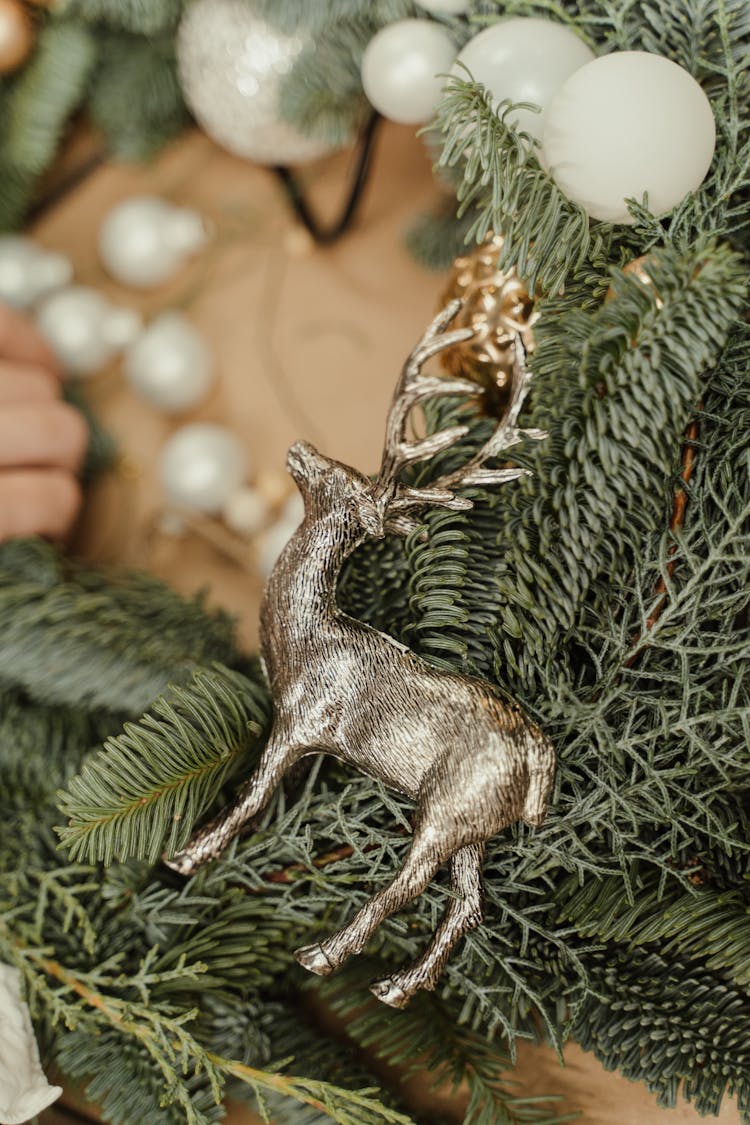 Gray Deer Christmas Ornament On Green Pine Leaves