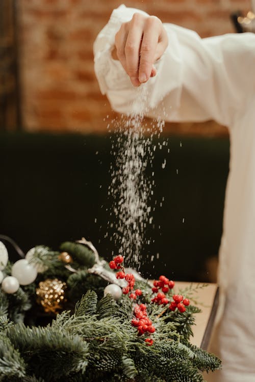 Person in White Dress Shirt Making a Frosted Winter Wreath