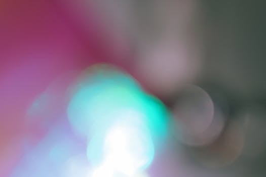 A vibrant abstract image featuring blurred light bokeh in various colors.