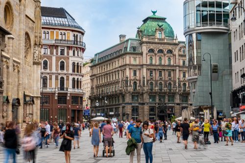Free Lively street scene capturing the busy urban life in Vienna's historic city center. Stock Photo